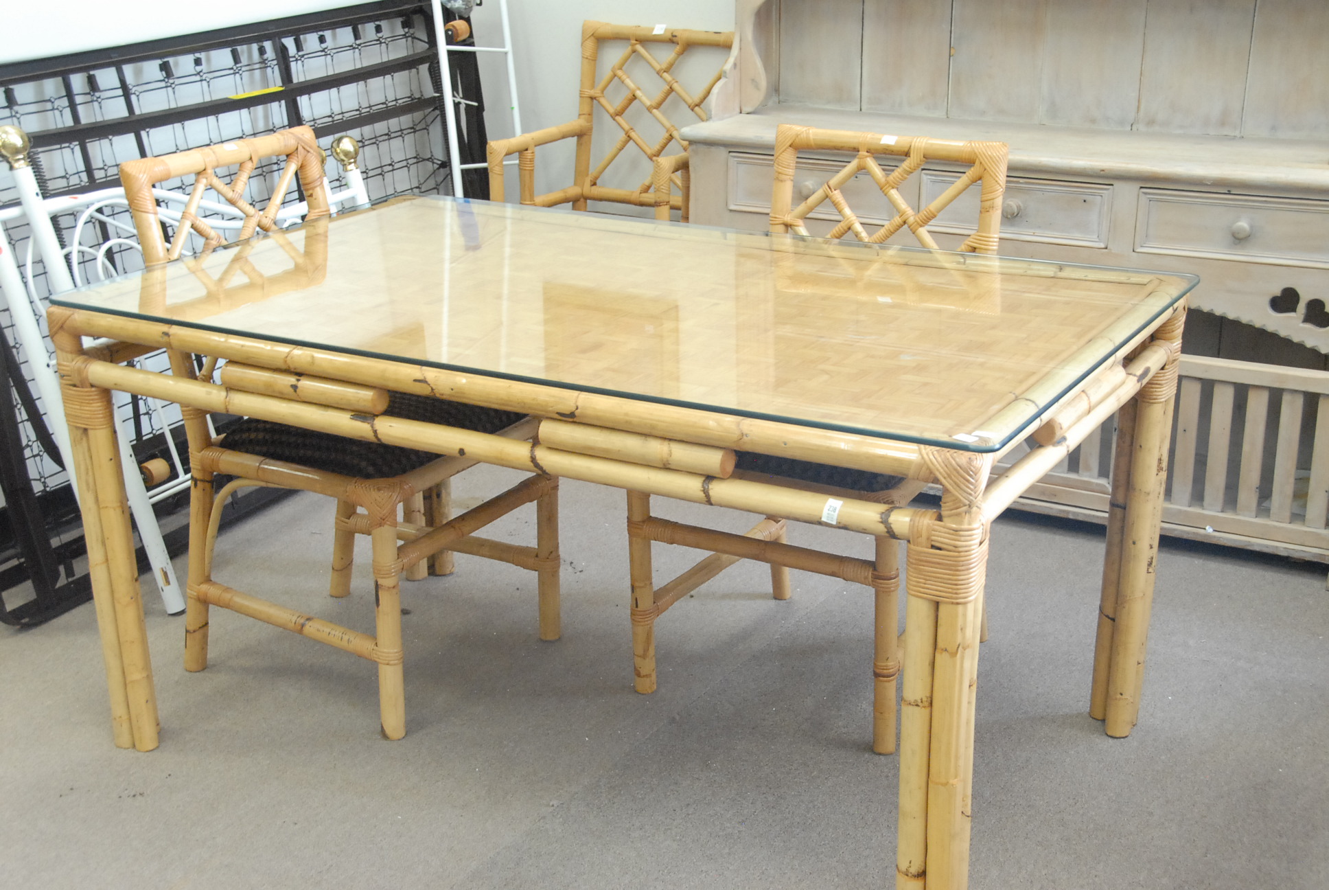 Lot 238 Bamboo table and four chairs, table has glass Nadeau's