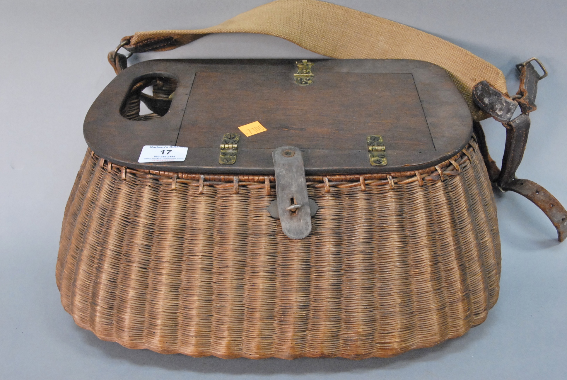 Lot 17: Split Willow fishing creel having wood top with compartment opening  to a fly box with flies, basket having leather strap and lock. h -  Nadeau's Auction Gallery