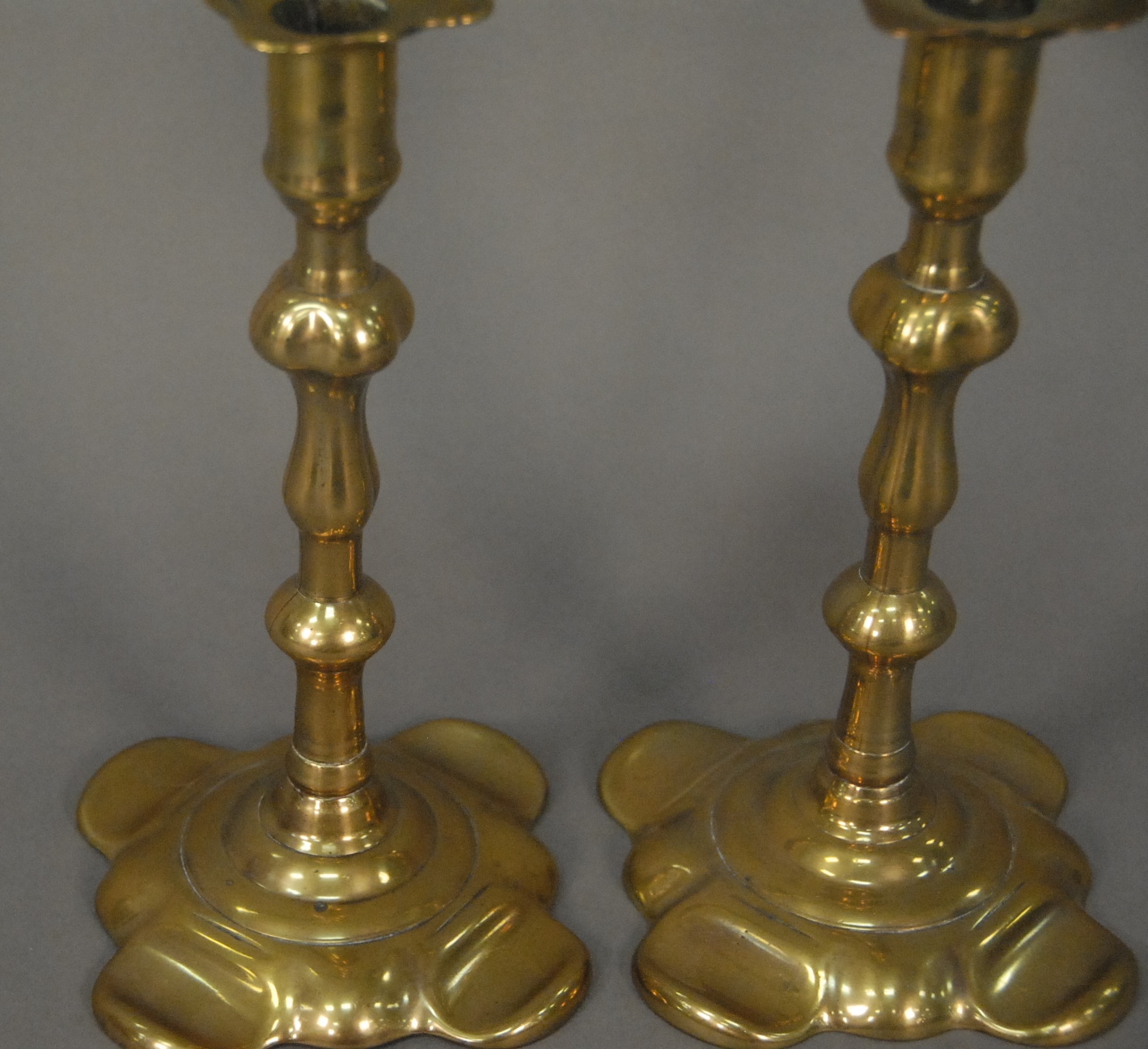 Lot 39D: Pair of George II brass candlesticks with petal bases
